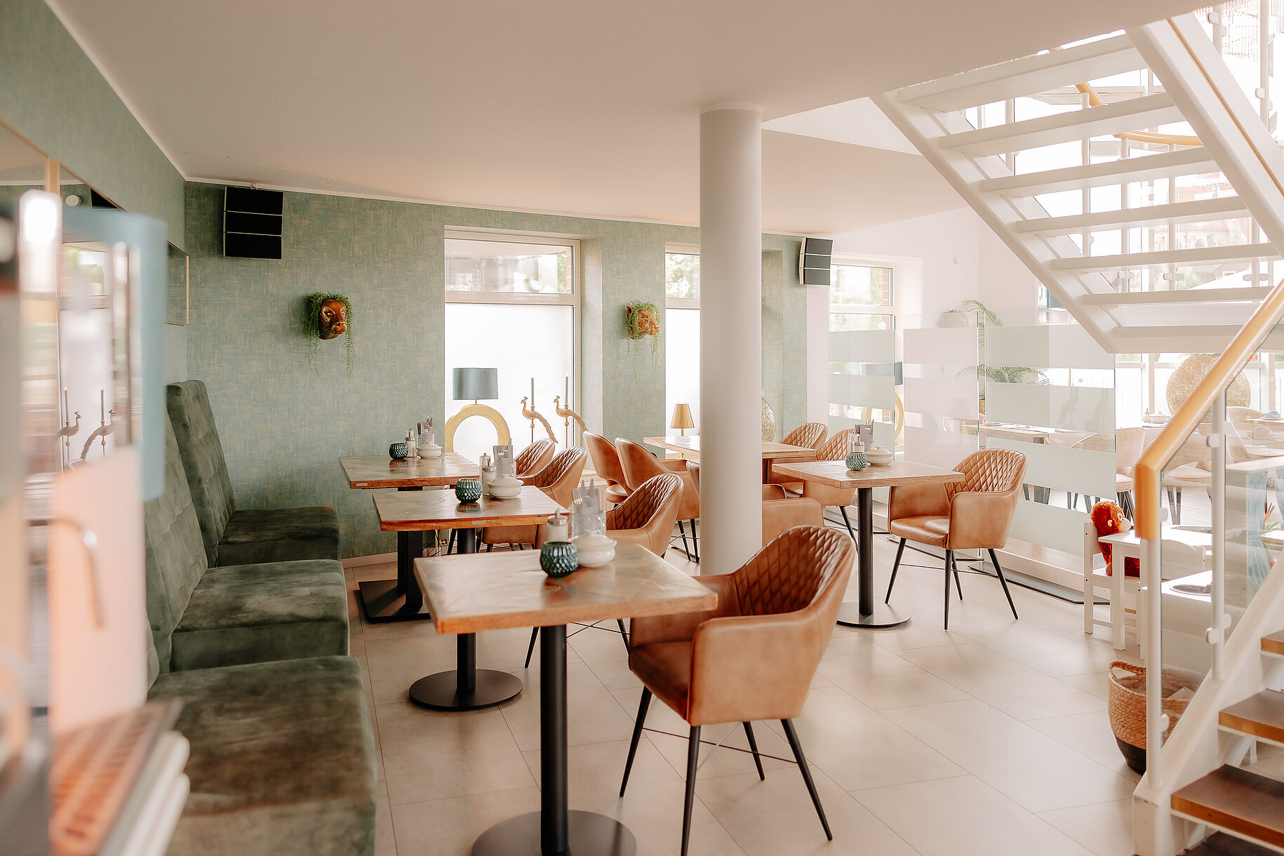 Sitzbereich im Erdgeschoss des CASCADA Hotel Rheine Gemütlicher Sitzbereich mit modernen Sesseln und grünem Wanddesign im CASCADA Hotel Rheine