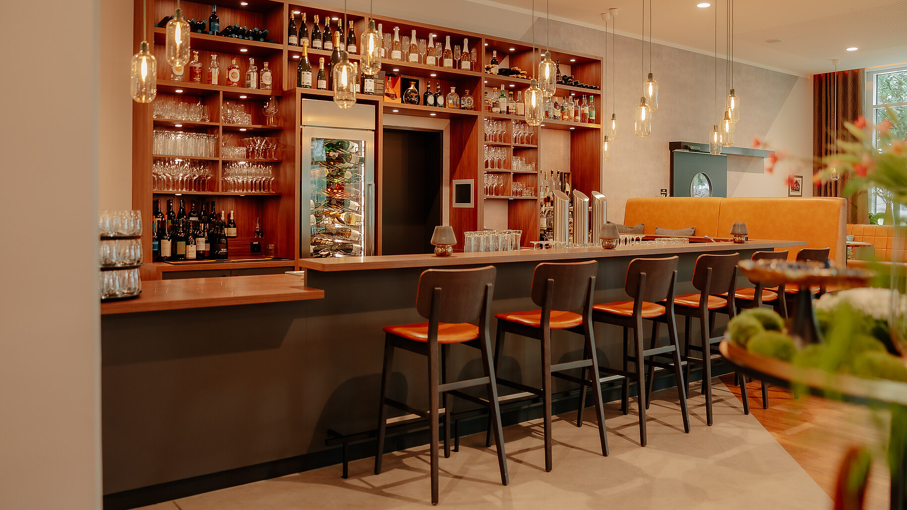 Hotelbar mit hochwertigem Getränkeangebot Moderne Hotelbar mit stilvoller Theke, Barhockern und gut sortiertem Getränkeangebot